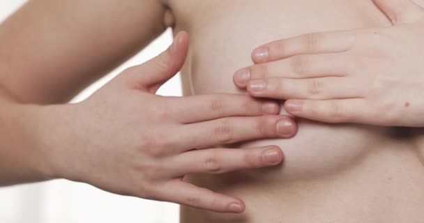 Woman checking her breast for signs of breast cancer. Healthcare and mammology concept. Close up. — Stock Video