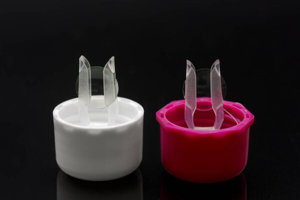 Contact lenses for keratoconus on a black background to mean a medical concept