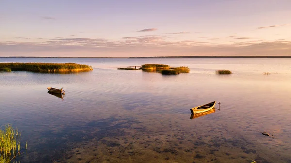 Boats on Lake in summer sunset light.