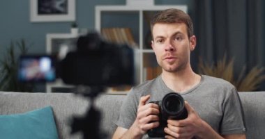 Handsome guy testing new digital camera and filming video