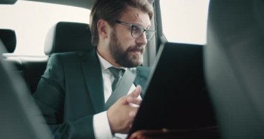 Otomatik görüntülü konuşma için laptop kullanan ciddi bir adam