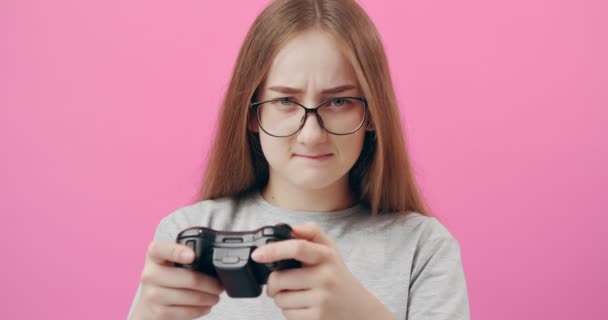 Opgewonden meisje in bril met joystick voor het spelen van games — Stockvideo