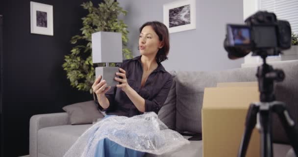 Woman recording on camera unpacking process of new goods — Stock Video