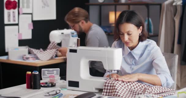 Designers tailoring clothing collection at sewing machines — Stock Video