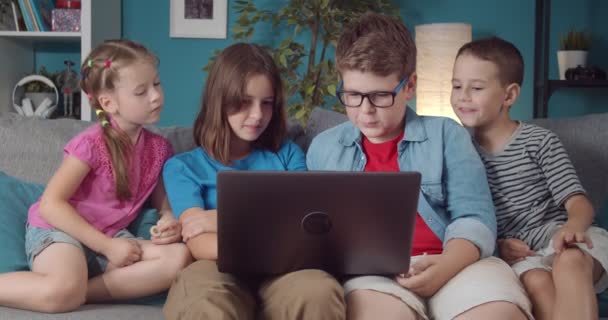 Smiling boys and girls watching favorite cartoon on laptop — Stock Video