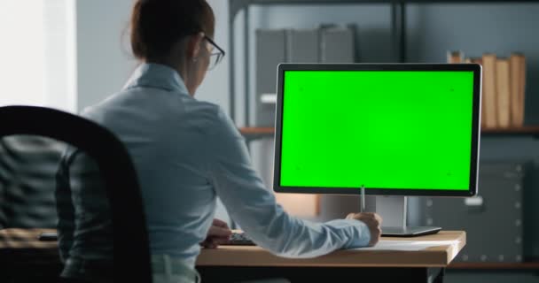 Mujer tomando notas durante la videoconferencia en el ordenador — Vídeos de Stock