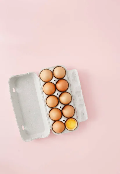 Kyllingegg Halvknust Blant Andre Egg Eggkartong Rosa Bakgrunn Flat Egglegging – stockfoto