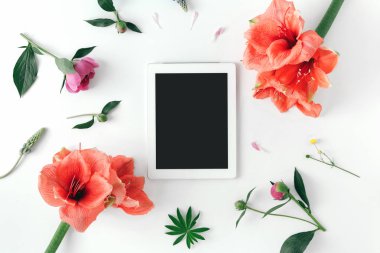 Ofis tablo masası ile tablet, defter, kalem, çiçek nergis zambağı, akıllı telefon, kahve fincanı, çanta, kol saati ve parfüm, sosyal medya.