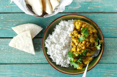 Karnabahar baharatlı köri pirinç ve naan ekmek üzerinde ahşap arka plan