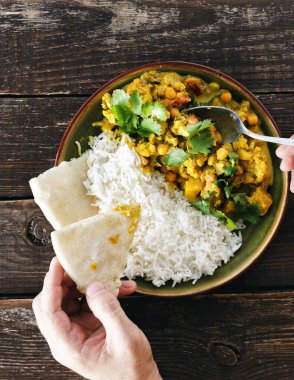 Karnabahar baharatlı köri pirinç ve naan ekmek üzerinde ahşap arka plan