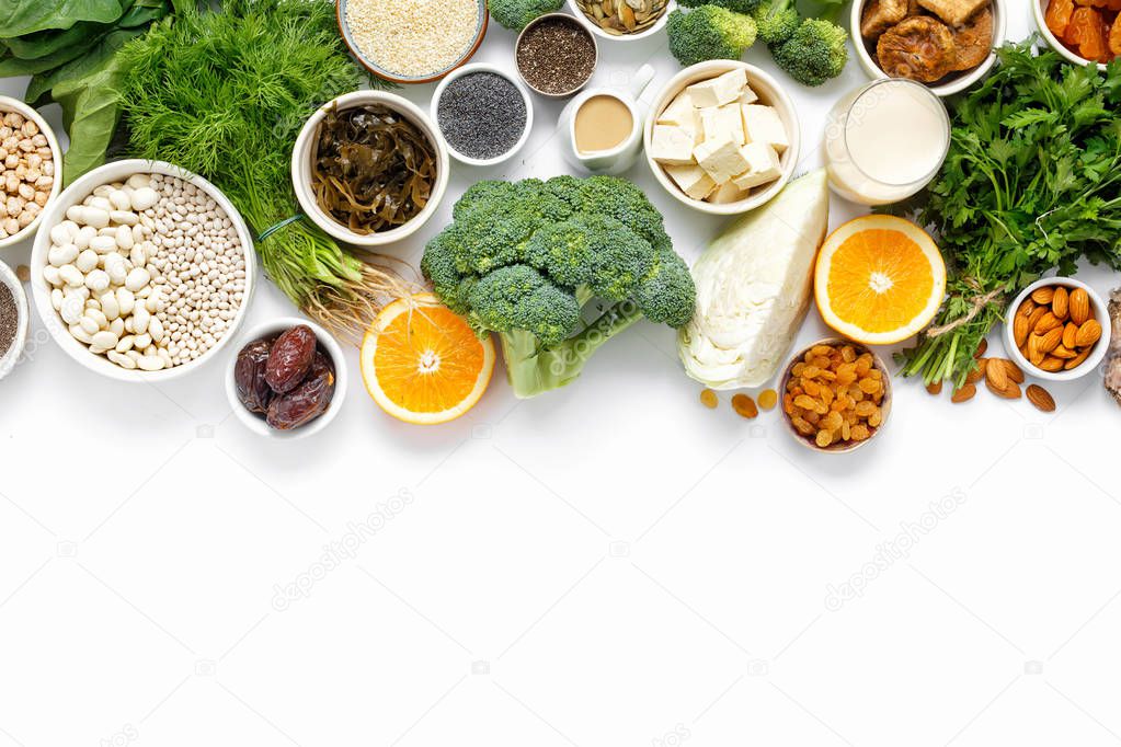 Source of calcium for vegetarians. Top view healthy food clean eating: fruit, vegetable, seeds, superfood, leaf vegetable on white background with copy space