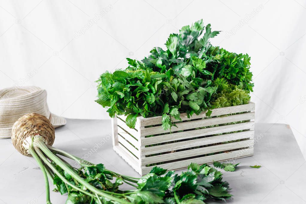 wooden box with freshly herbs on white background