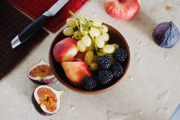 Bowl of various fruits blackberry figs grapes peach