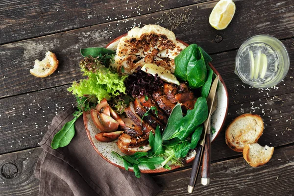 Clean and balanced healthy food concept. Healthy lunch. Fried chicken steak, vegetables and lettuce on dark wooden background top view flat lay