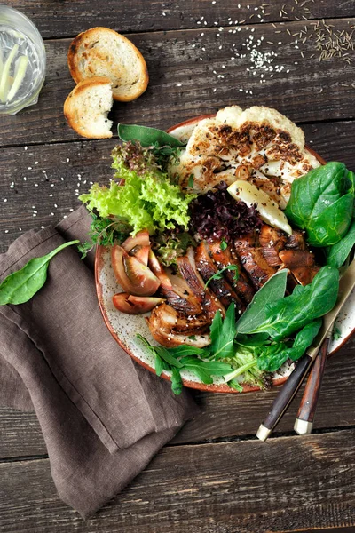 Clean and balanced healthy food concept. Healthy lunch. Fried chicken steak, vegetables and lettuce on dark wooden background top view flat lay