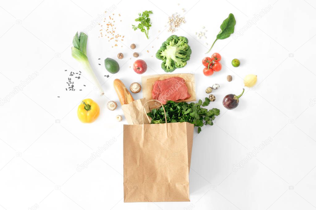 Full paper bag of different health food on white background. Top view. Flat lay