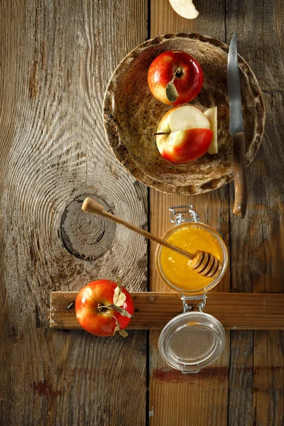 Olgun sulu kırmızı ev yapımı elma rustik masada bal ile 
