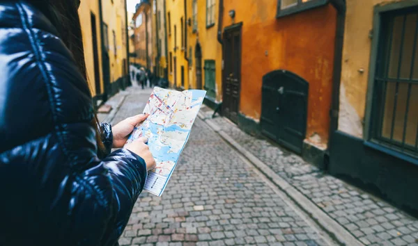 Woman traveler with map in hand on streets of Stockholm