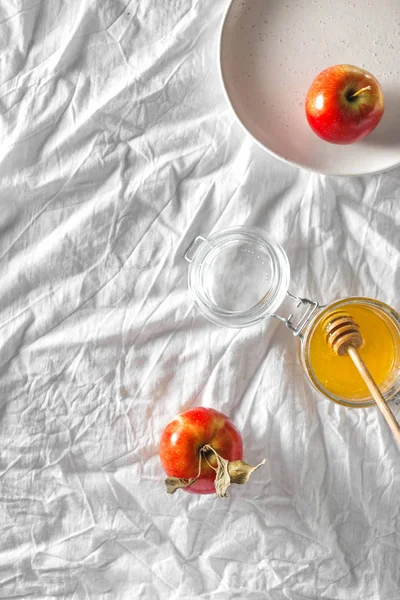 Juicy red homemade apples with honey on rustic table