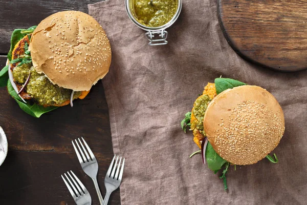 Vegetarian burger with pumpkin cutlet, spinach, arugula and vegetarian pesto sauce