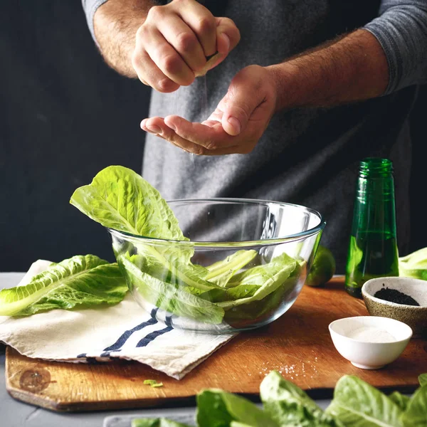 Healthy Lifestyle. Man Cooking Green Salad Of Romaine Lettuce. Healthy Food concept