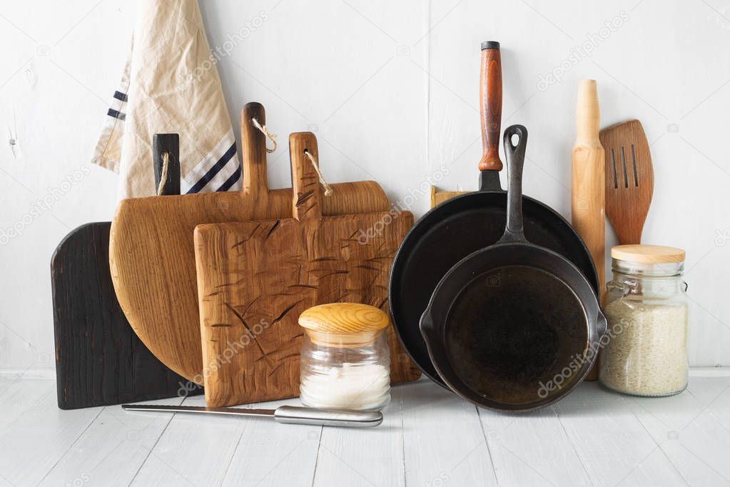 Rustic still life. Set of wooden kitchen utensils on white wooden kitchen table