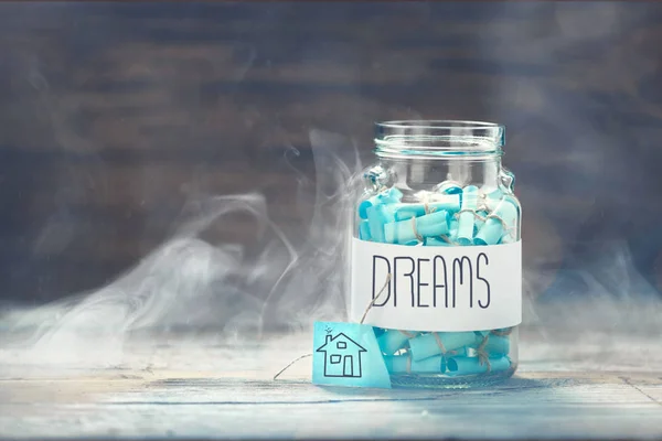 Dreams jar. Dream house concept. Full glass jar of cherished wishes