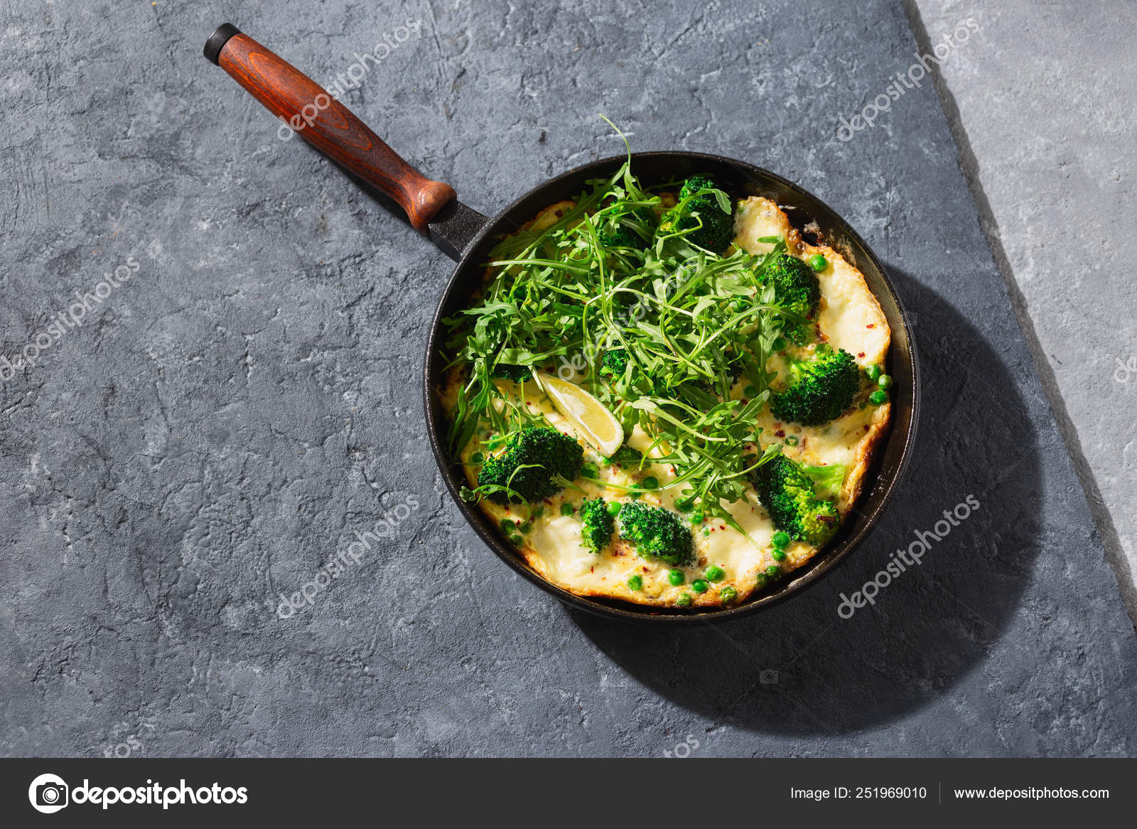 Frittata with broccoli,green peas mozzarella cheese frying pan top view
