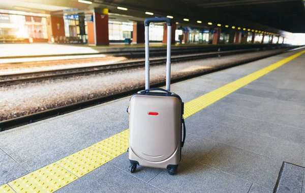 Suitcase on the platform of the railway station