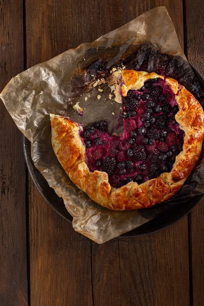 Fruit pie with strawberry, blueberry, blackberry and raspberry on a wooden background top vie