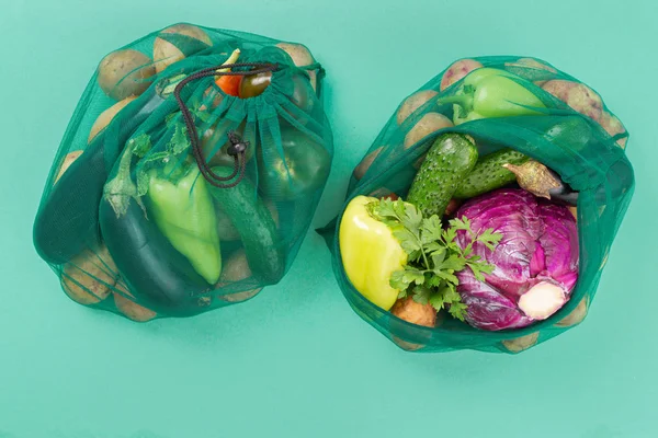 No plastic bag concept. Mesh bag of different vegetables. Top view. Flat lay
