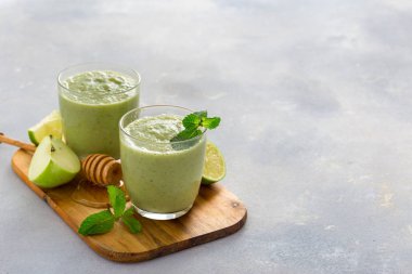 Sağlıklı temiz beslenme konsepti Kahvaltı içkisi Yeşil smoothie elma ıspanak kireç ve bal kopya alanı ile bir masada