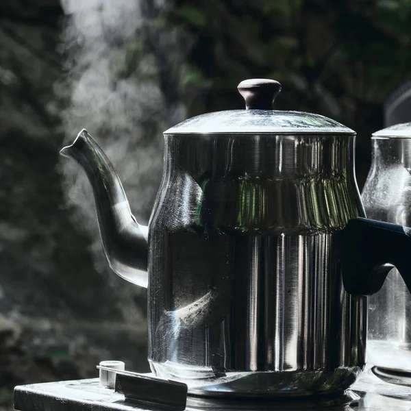 Camping camp holidays concept. Two teapots with hot tea