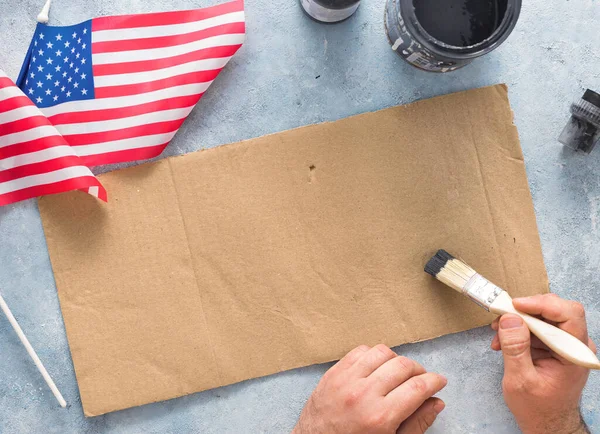 Man activist preparing banner for protests top view — Stock Photo, Image