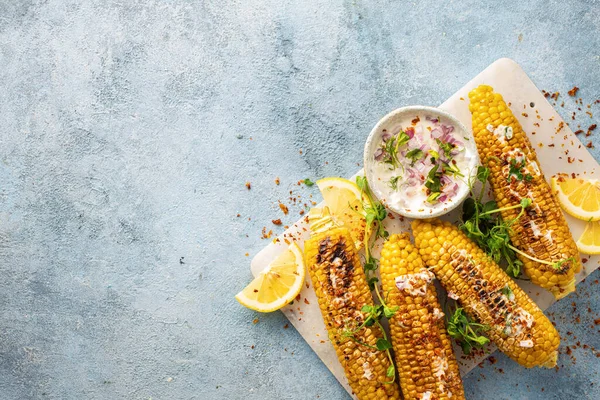 Vegan dinner with grilled sweet cob corn top view with copy space. Summer vegetarian snacks