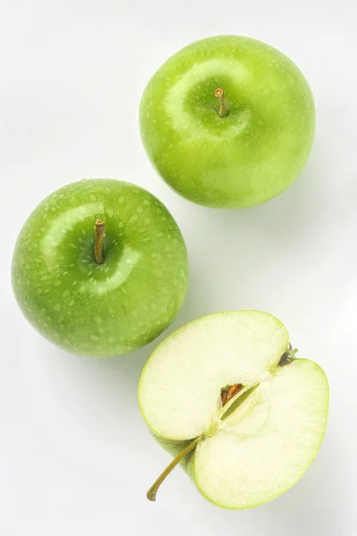 Half of ripe green apples on a white background. Top view