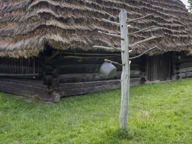 Polonya 'nın Kolbuszowa kentindeki açık hava müzesinde yeniden inşa edilen tarihi köy. Eski ahşap ev. Tencere ve giysileri kurutmak için ahşap askı..