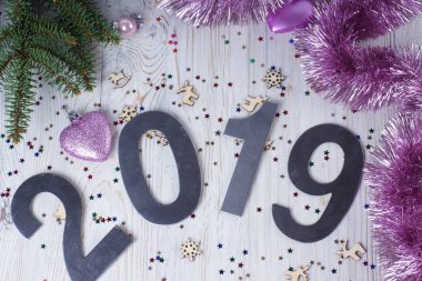 Noel kavramı - Noel tinsel dekorasyon ve yazıt 2019 ile yaprak dökmeyen ağaç dalları üzerinde pembe kalp.