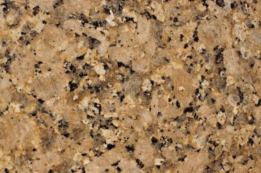 Koyu lekeler ile doğal taş sarı-kahverengi granit