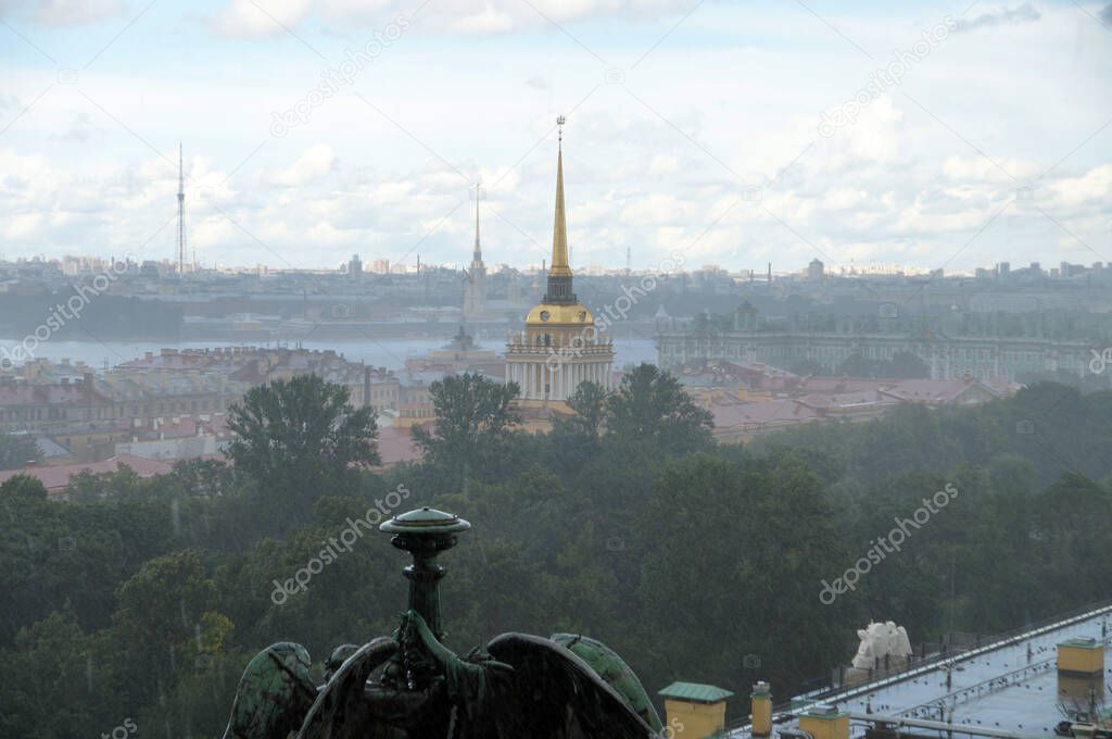 View from the height of St. Isaac's Cathedral in St. Petersburg to the rainy city and the spire of the Admiralty.