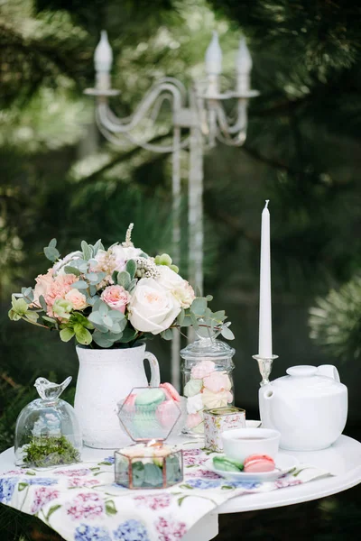 Still life brides morning, dish with cup of tea, champagne glass, wedding rings and flower bouquet