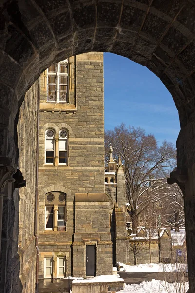 WASHINGTON DC, USA - JANUARY 15, 2019: Gothic architecture of Healy Hall building profile framed by its porch arch in snowy winter.