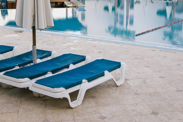 summer vacantion. deck chairs by the pool. relaxation