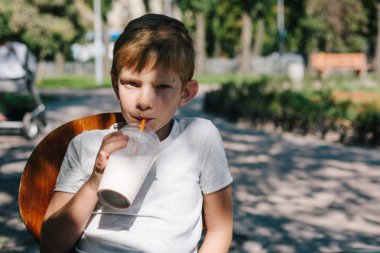 yaz günü. 7 yaşında çocuk açık milkshake içme