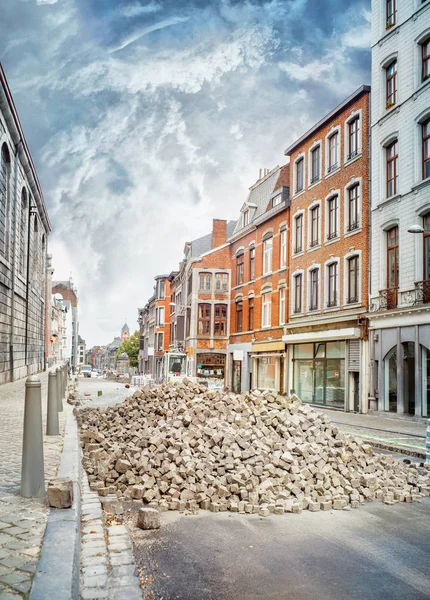 Paving works on the street of the old town of Liege.A  large pile of paving stones. Belgium
