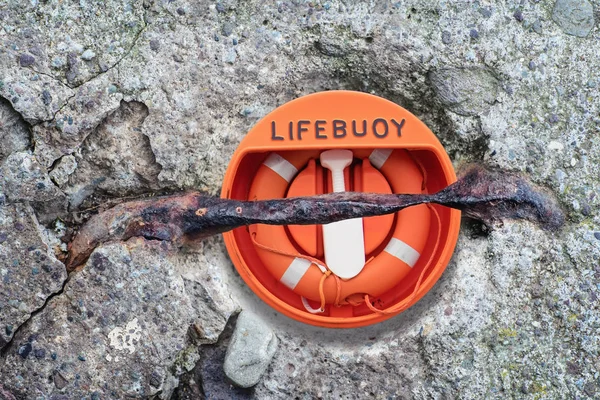 Lifebuoy під іржавим металевим стрижнем у бетонній поглибленні — стокове фото