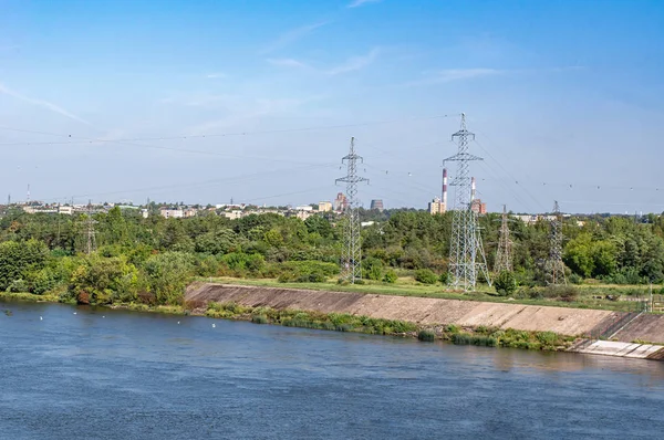 High voltage steel poles on the river bank — Stock Photo, Image