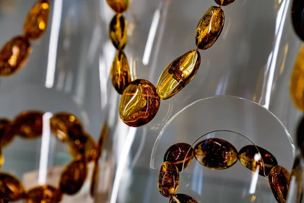 Amber neklace and bracelet on a glass shelf — Stock Photo, Image