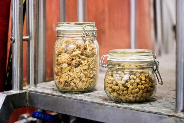Dried and pressed hope cones in jars in a brewery — Stock Photo, Image
