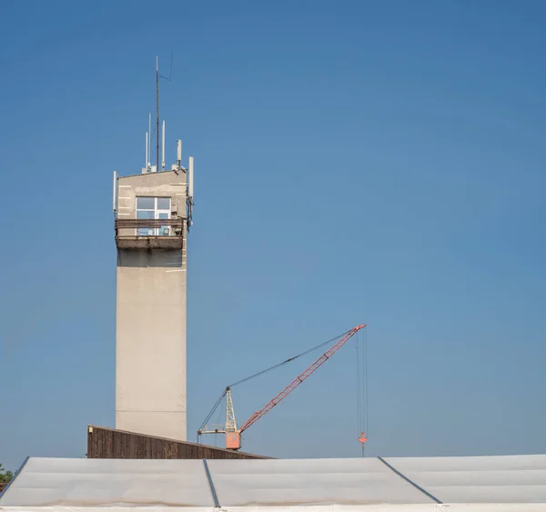 Tower with antennas and a construction crane — Stock Photo, Image